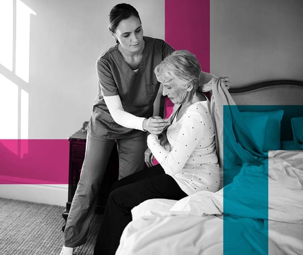 Home care nurse helping elderly woman out of bed