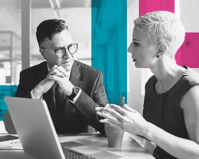 Two business people in a meeting with open laptop