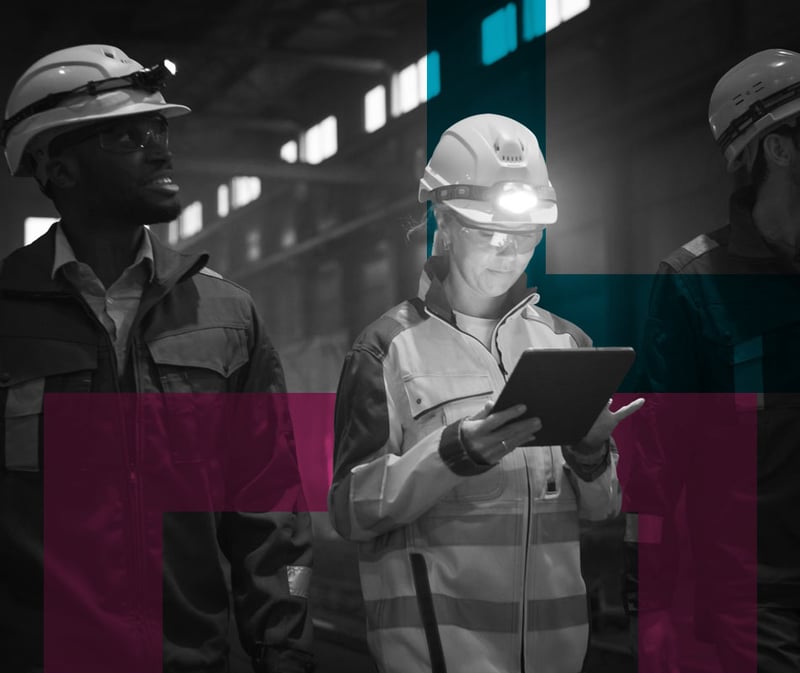 Woman in high vis with headlight looking at ipad