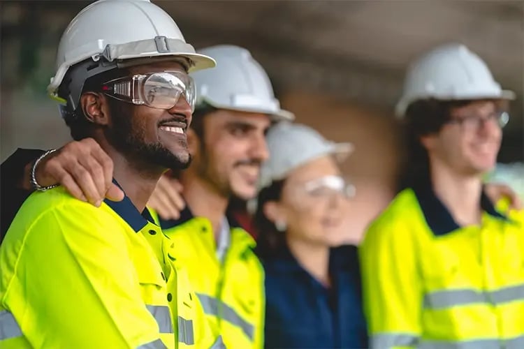 Men in high vis smiling