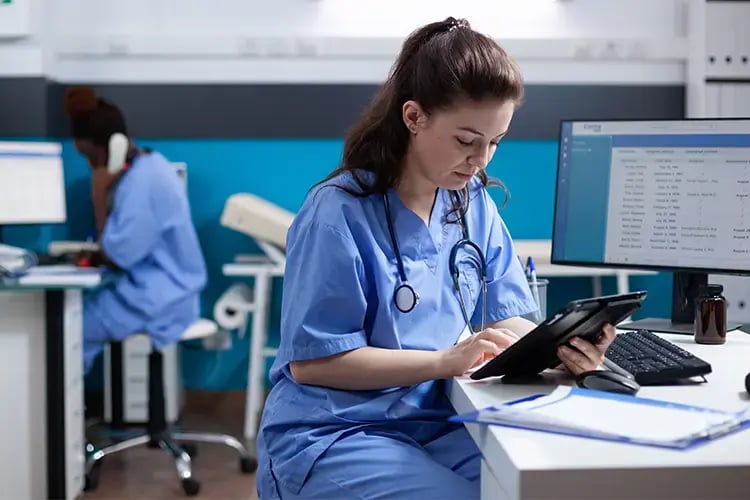 Nurse on ipad in office