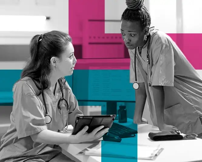 Two nurses looking at an ipad in an office