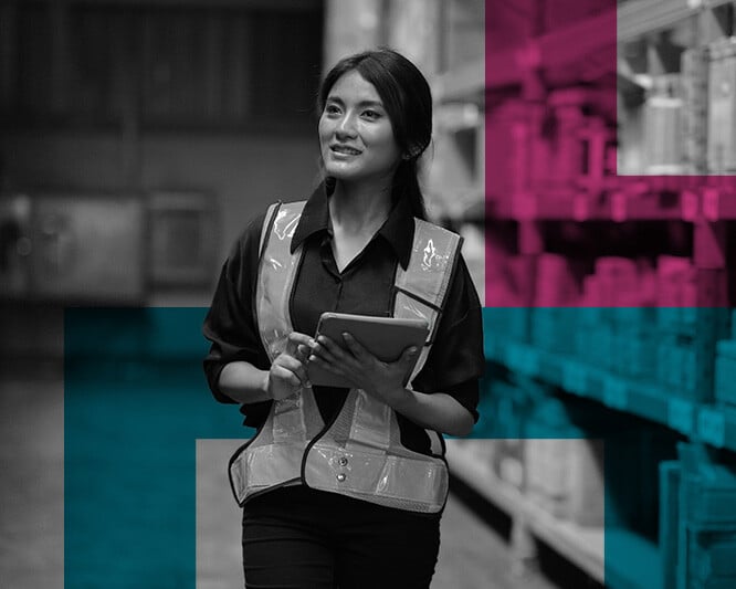 Woman with ipad walking through warehouse