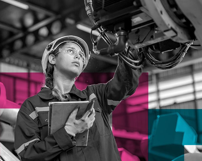 Tradeswoman inspecting a machine with ipad