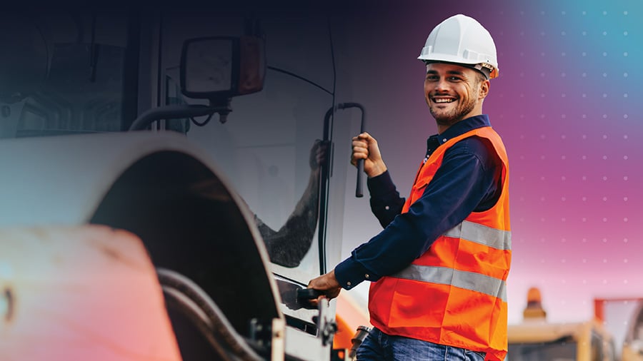 Man in high vis getting into machine