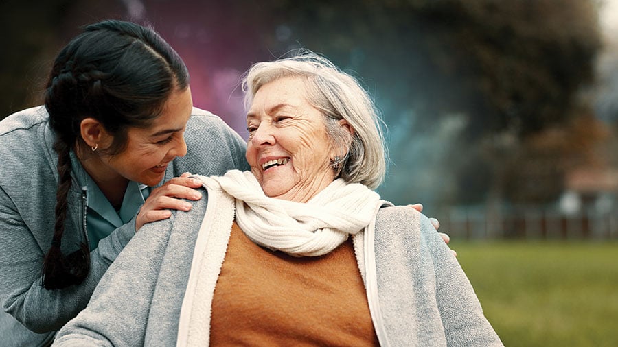 younger woman leaning over elderly lady